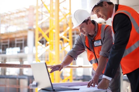 Construction workers utilizing BIM for load analysis